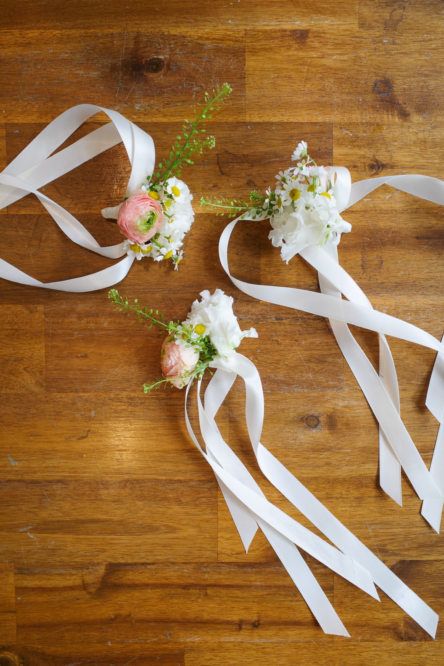ranunculus, chamomile, and lisianthus wrist corsage