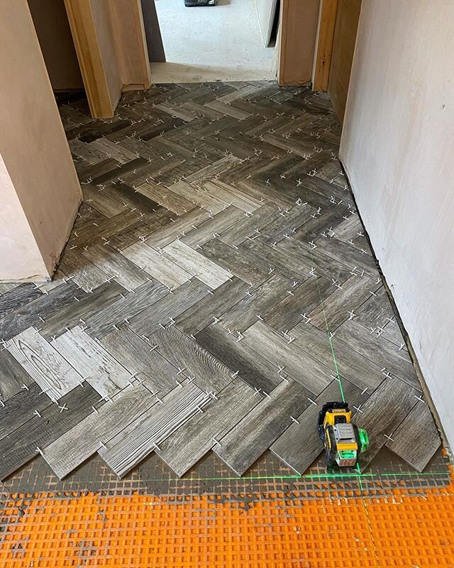 Herringbone floor going down. @schlutersystemsuk used on this heated floor. @dewalttoolsuk @dewalttough laser keeping us straight and square. Stay tuned for this one as it&rsquo;s going to look 🔥🔥🔥. Tiles from @emctiles #herringbone #tiler #tiling