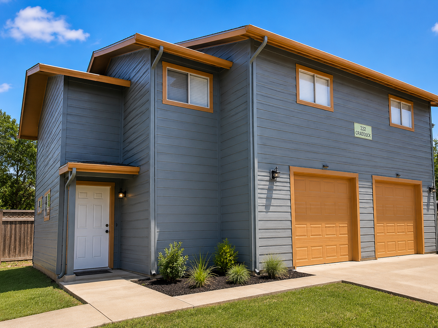 Exterior of 222 Craddock, a 3-bedroom pet-friendly duplex near Texas State University featuring Plank flooring, attached garage, and a large backyard in San Marcos, Texas.