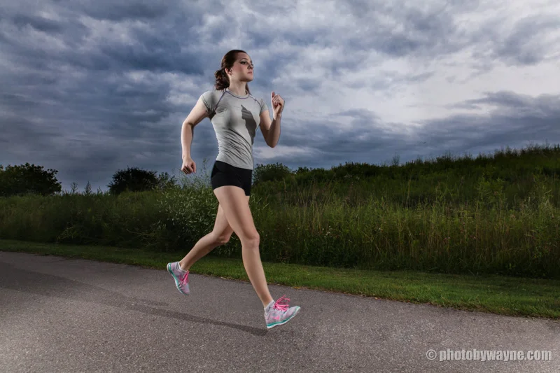 female-fitness-model-running-outdoor-dramatic-cloud