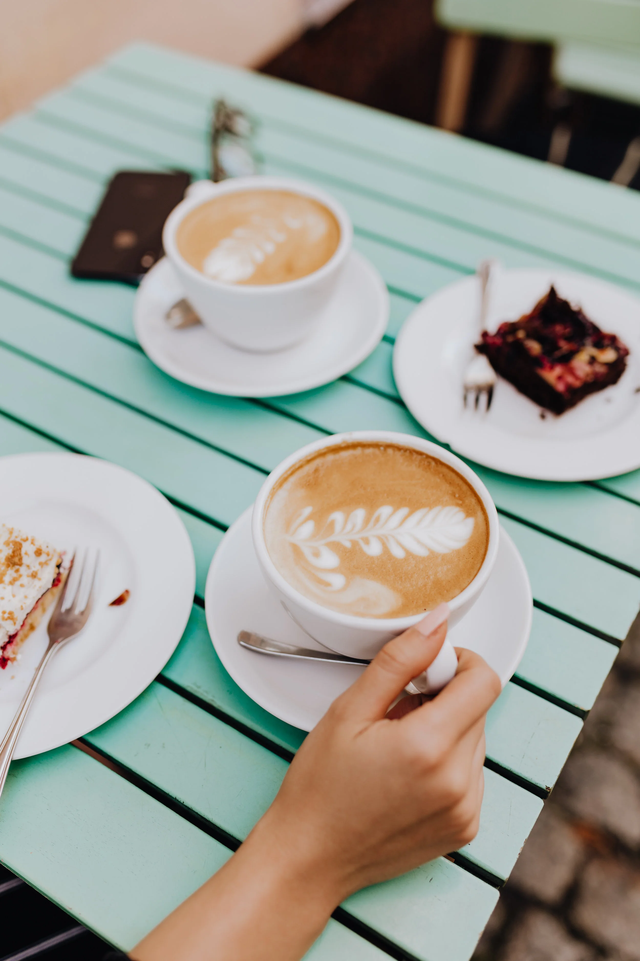 kaboompics_Drinking coffee and eating cake in a cafeteria.jpg