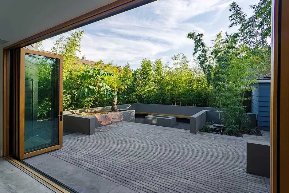 An outdoor patio is located directly outside the ADU, extending the indoor space to the outdoor space through the accordion doors. Photo by Carlos Rafael Photography