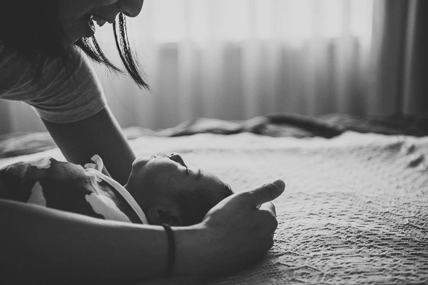 mother laying down baby