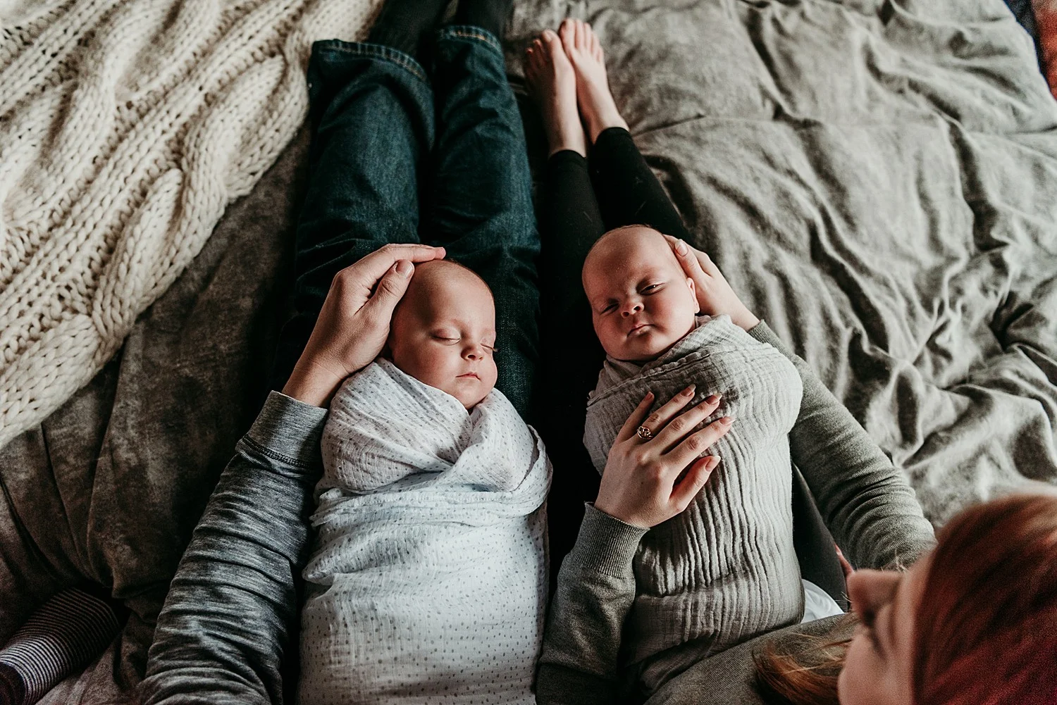 twin newborns cuddling