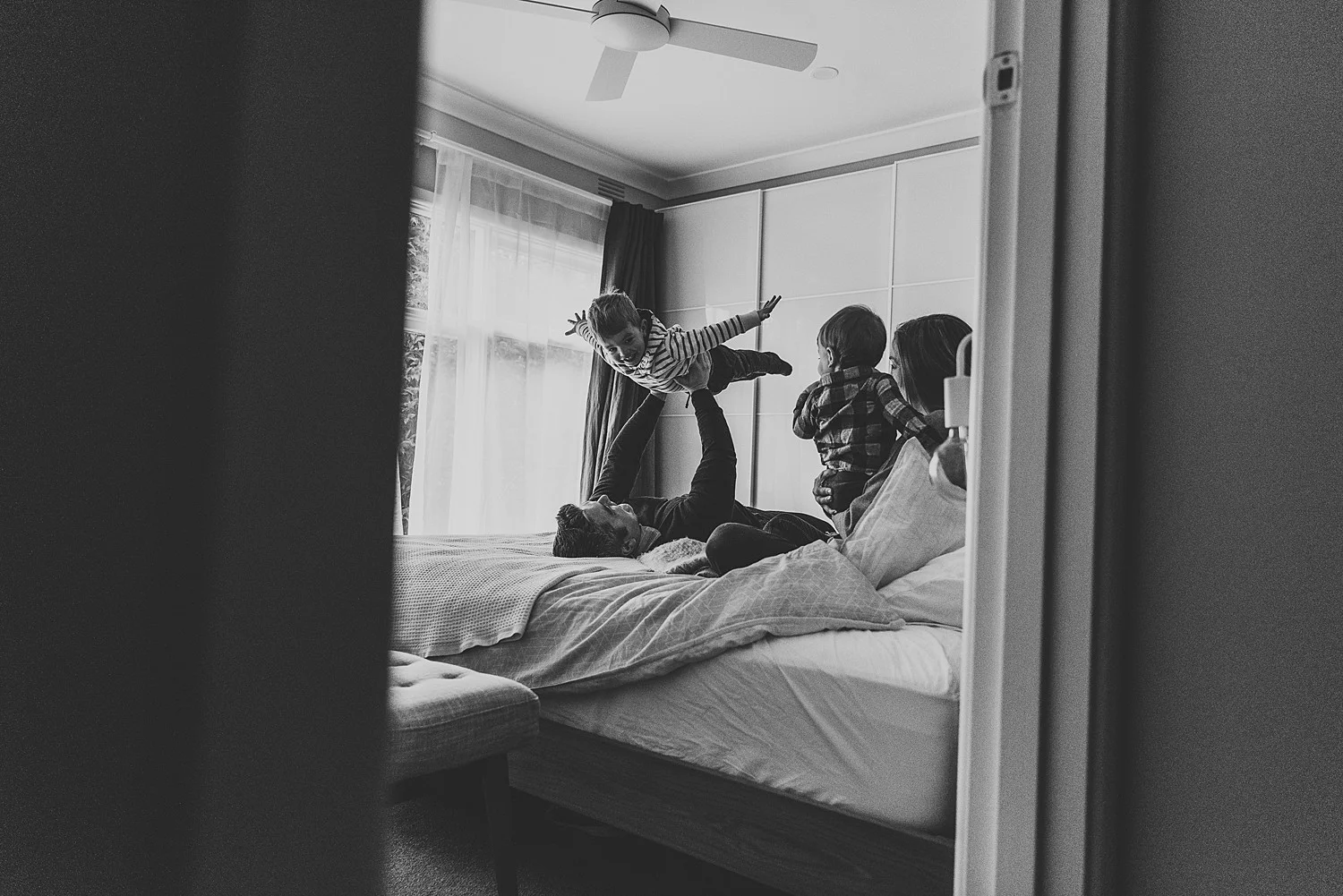 family playing on bed