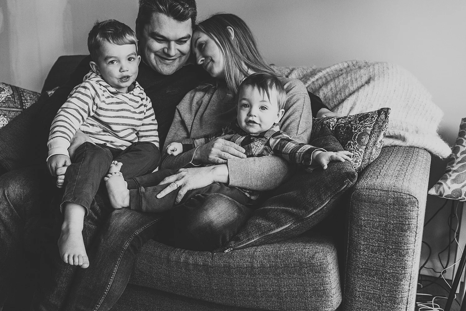 mum resting head on dads shoulder with kids