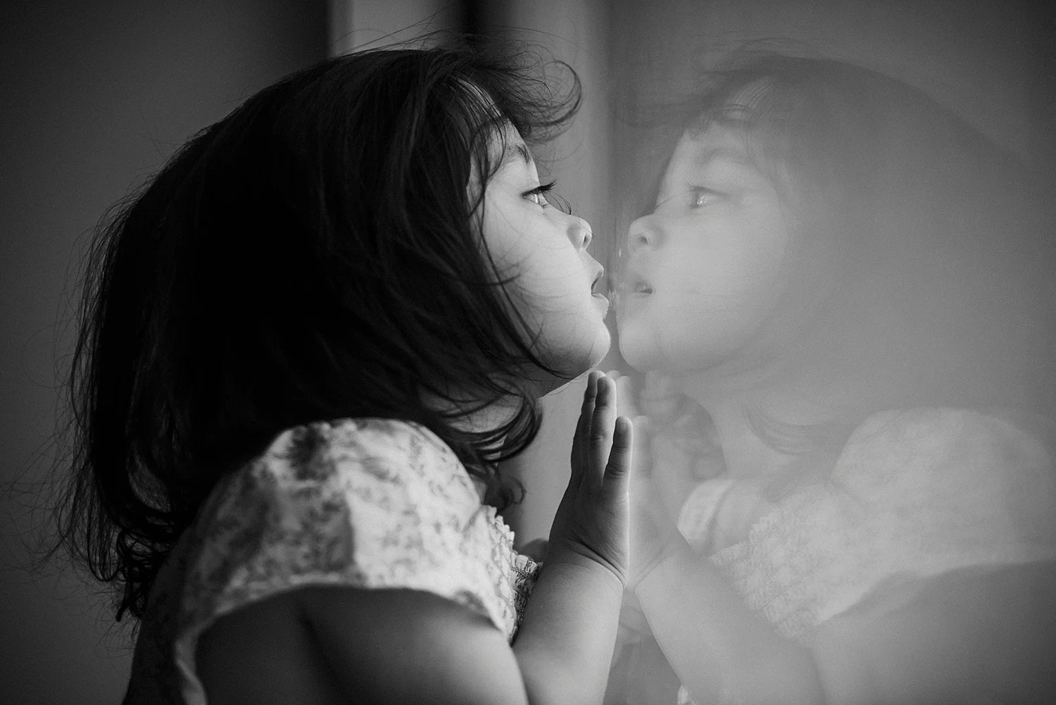 little girl looking at reflection