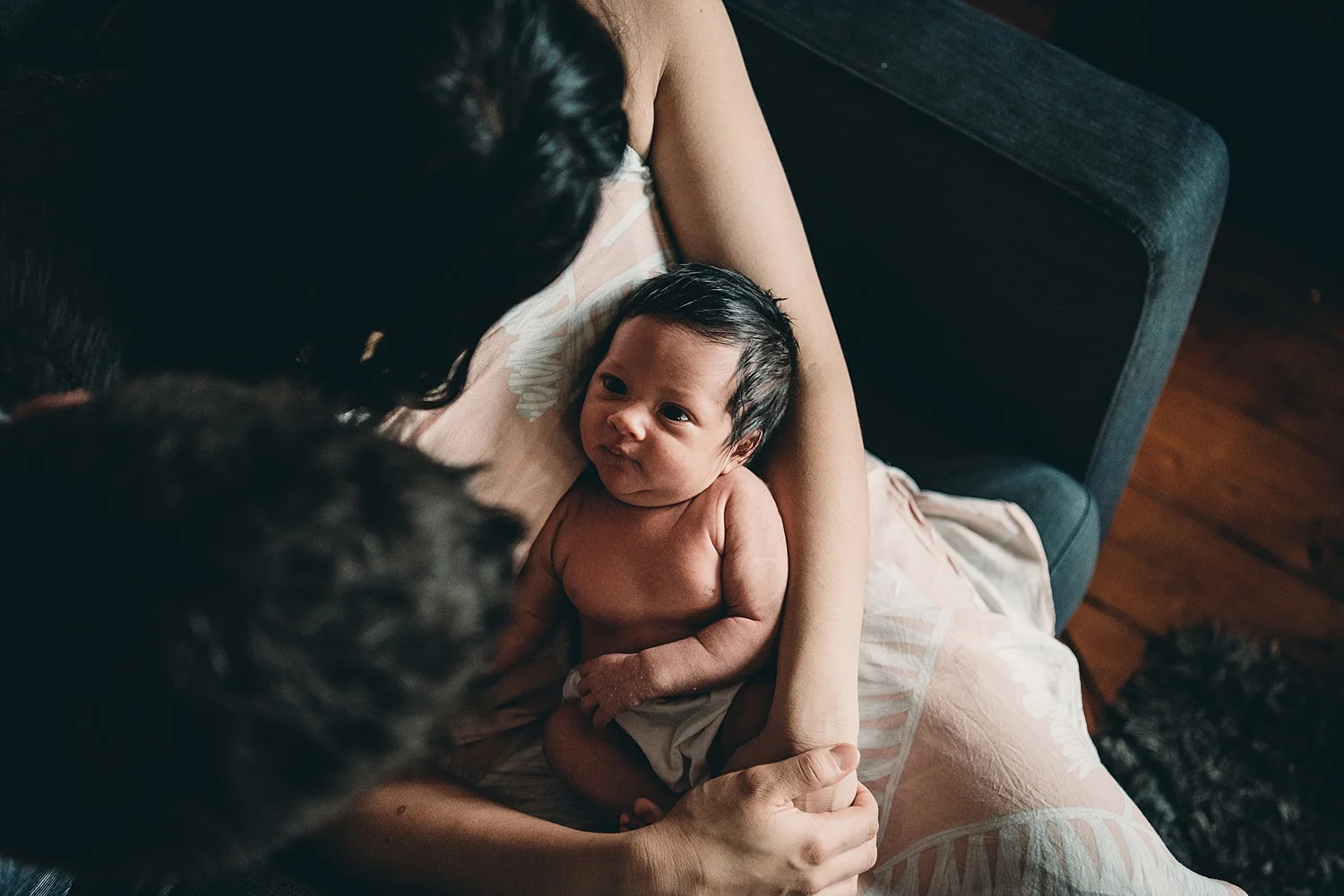 newborn looking at parents