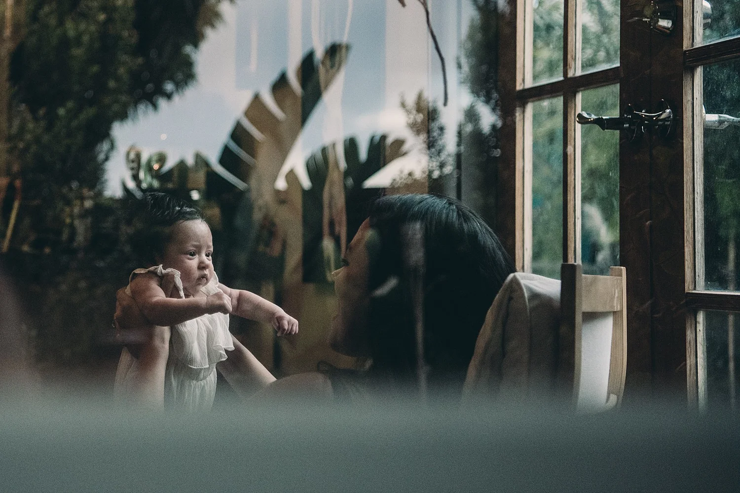 mother and baby through a window