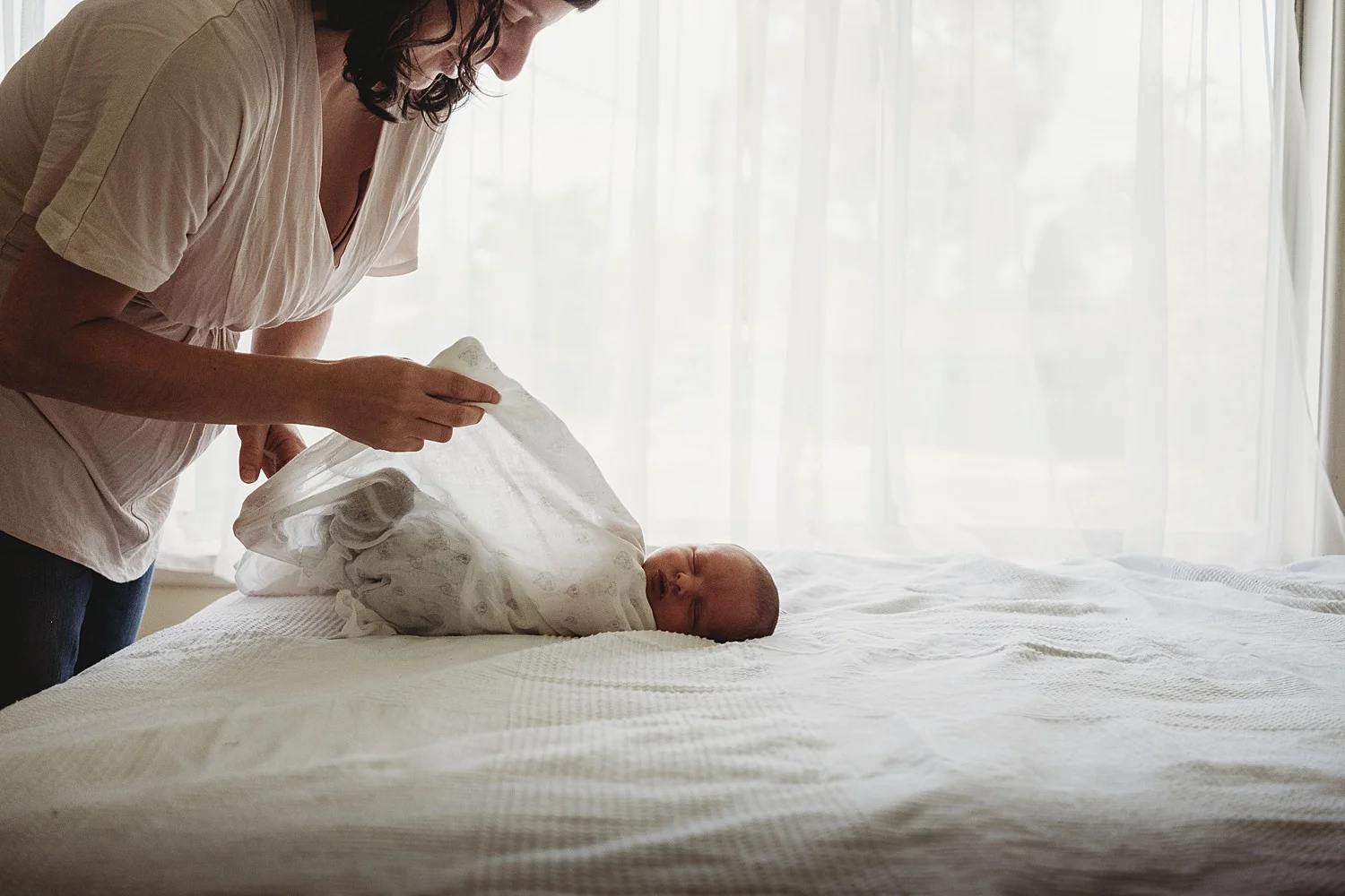 mother wrapping baby