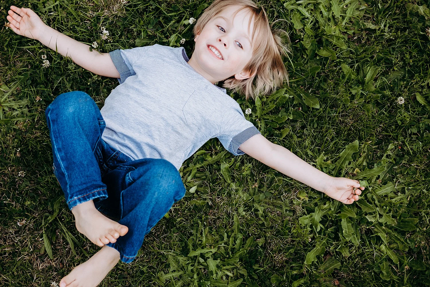 boy laying in grass