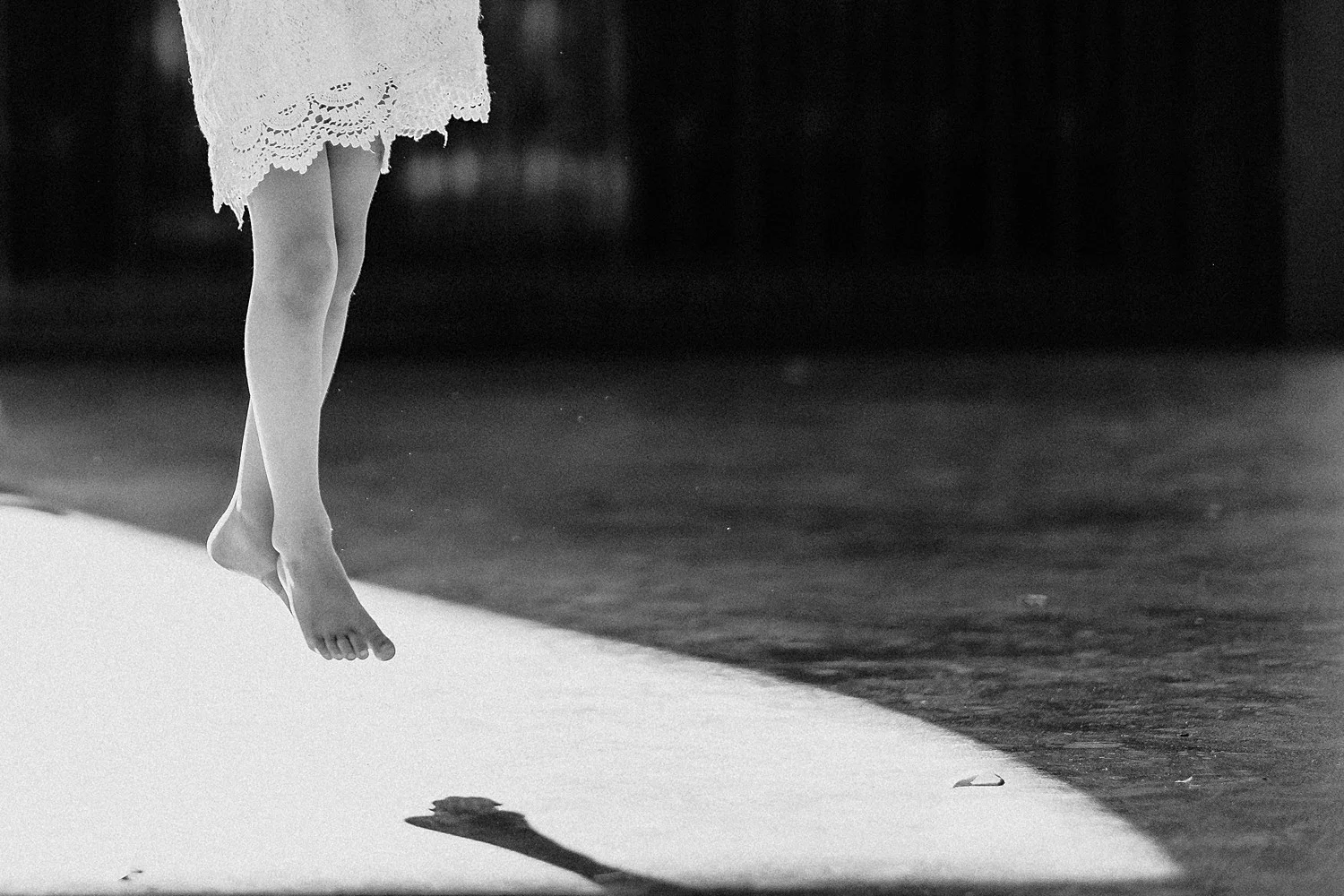 little girls jumping above shadow