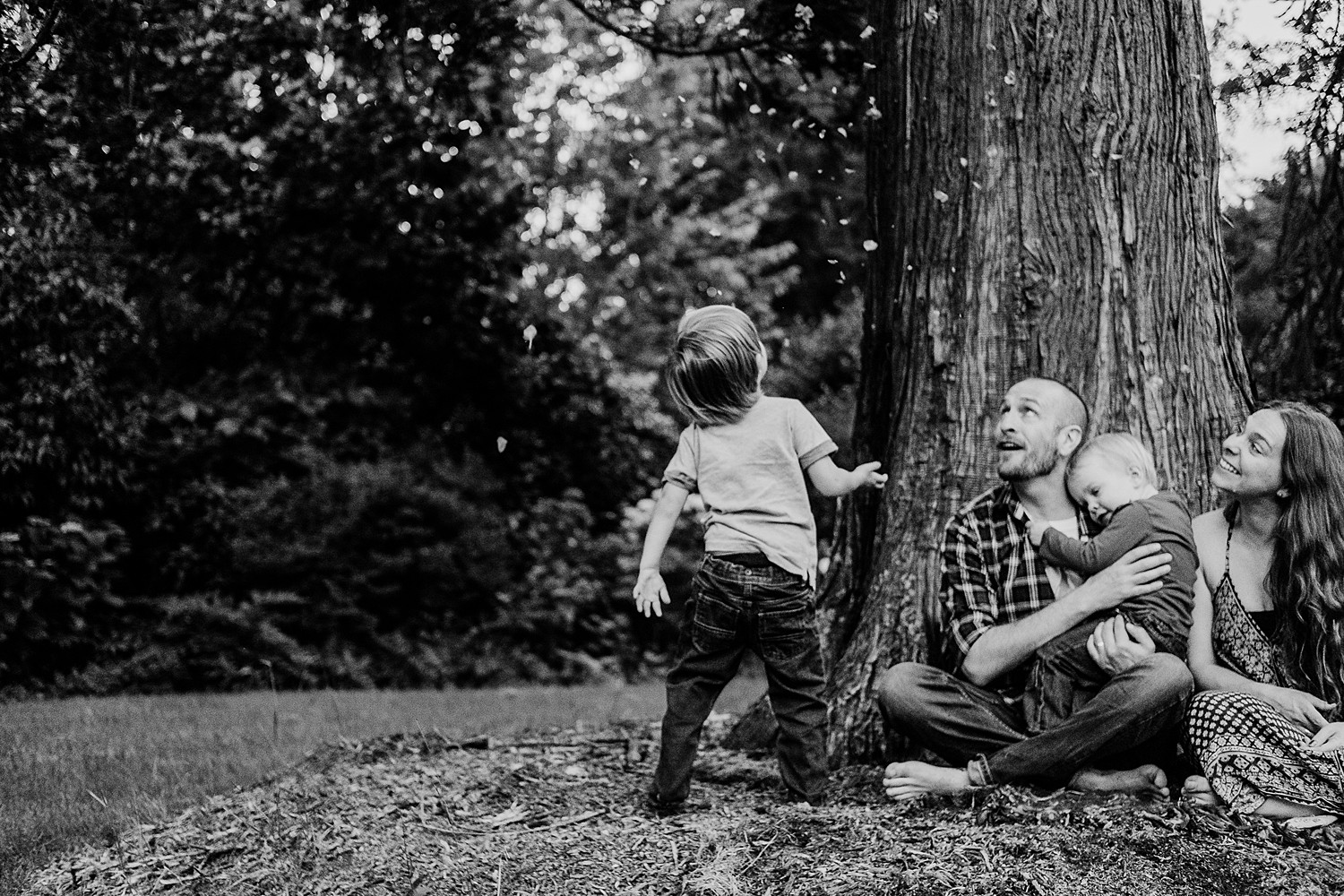 little boy throwing petals over family 