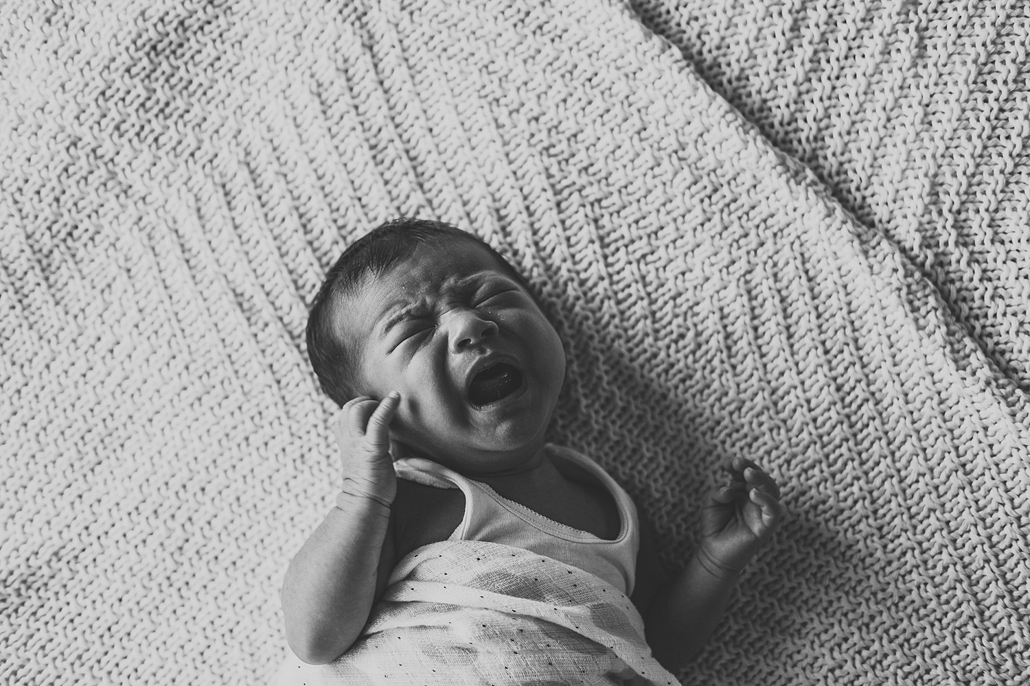 black and white crying newborn