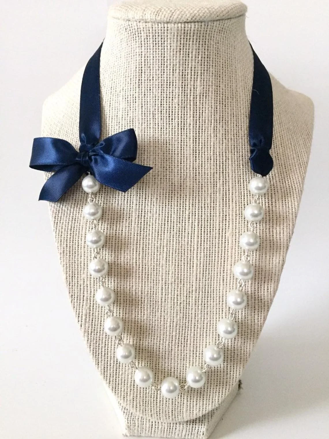 It’s been said that a Belle with pearls can change the world…these pearls have a lovely accent of a bow and our perfect for an extra pop with a t-shirt. Etsy Store: JewelryByAsheNicole
