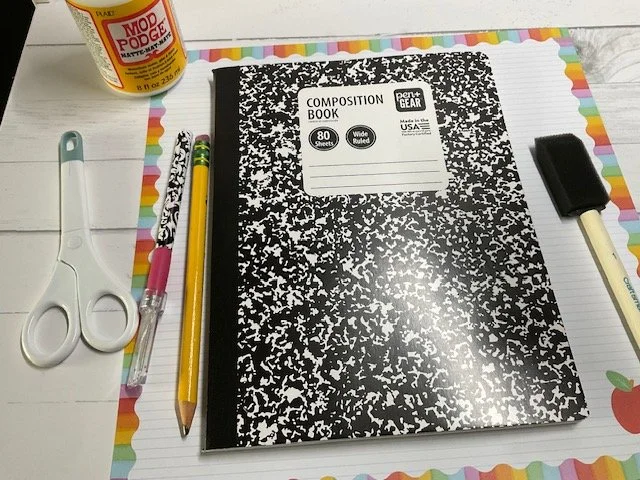 Compoosition notebook, scrapbook paper, pencil, modpodge, scissors