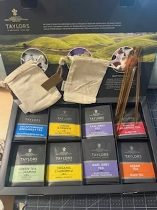 Picture of tea craft supplies, cotton bags, tea bags, and honey sticks