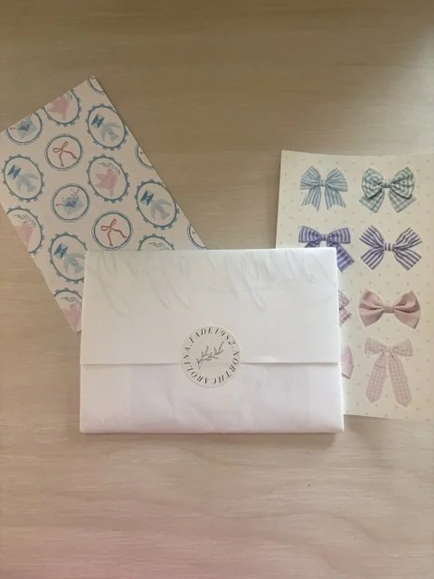Picture of an envelope from FADE 198 and postcards and stickers