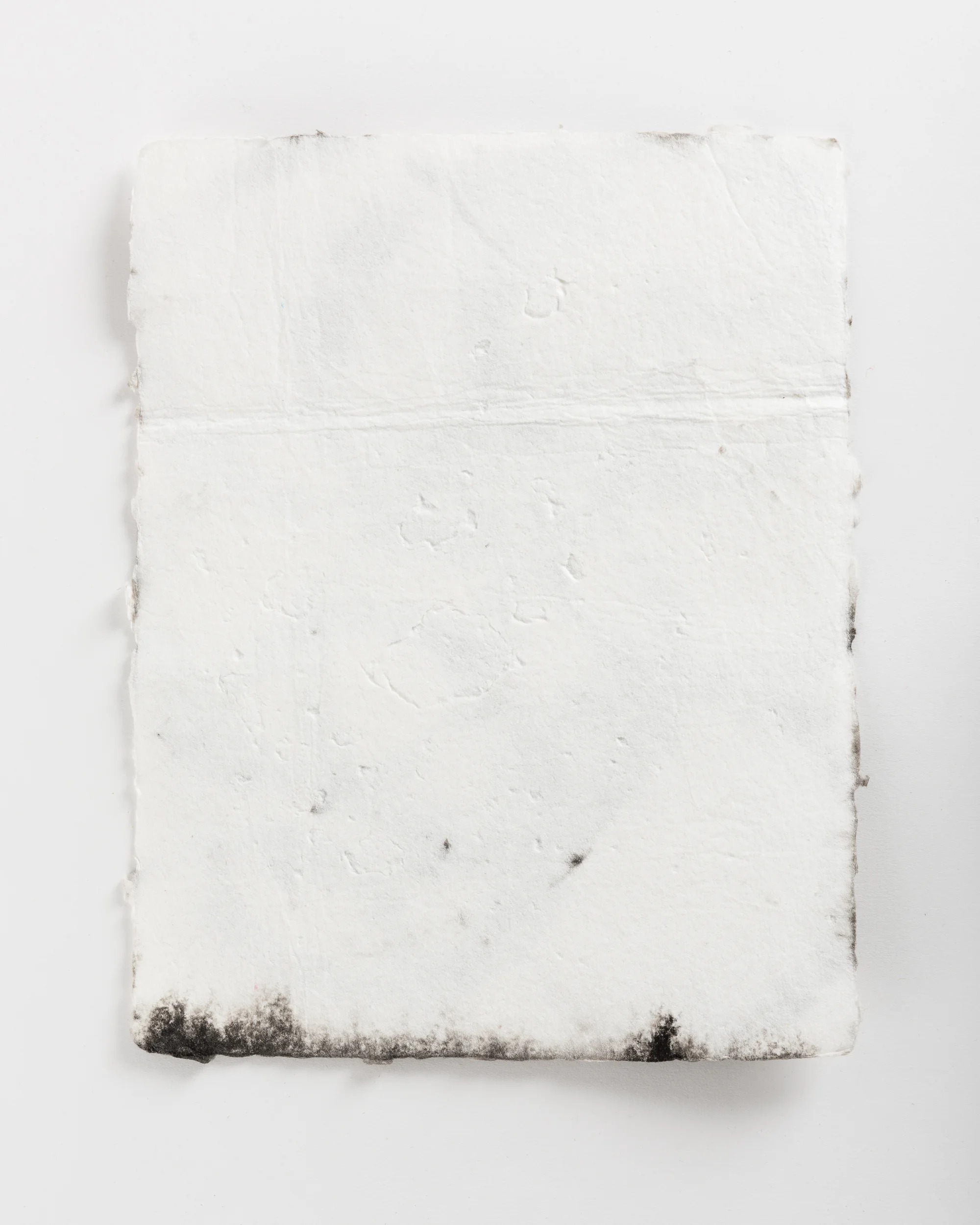 Handmade paper. Made by hydrating and beating cotton linter, and then forming 8x10 sheets onto a vacuum table and adding black pigment directly to the wet sheets.
