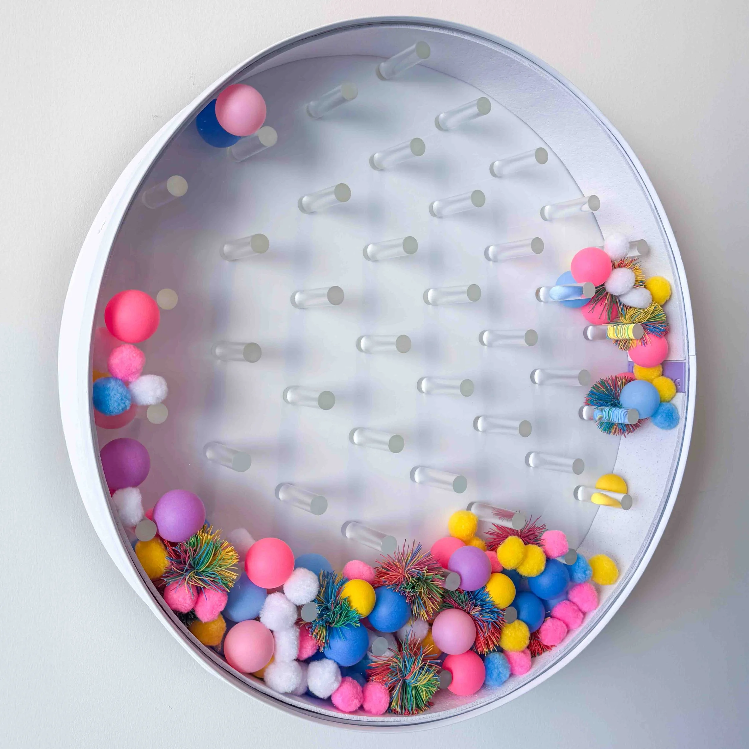    Plink Pong    Plink Pong is a wall-mounted visual, tactile, and auditory public intervention. It invites passersby to spin it and take a moment to get lost in the sound, sight, and touch. Produces sound and motion through spontaneous movement.  No