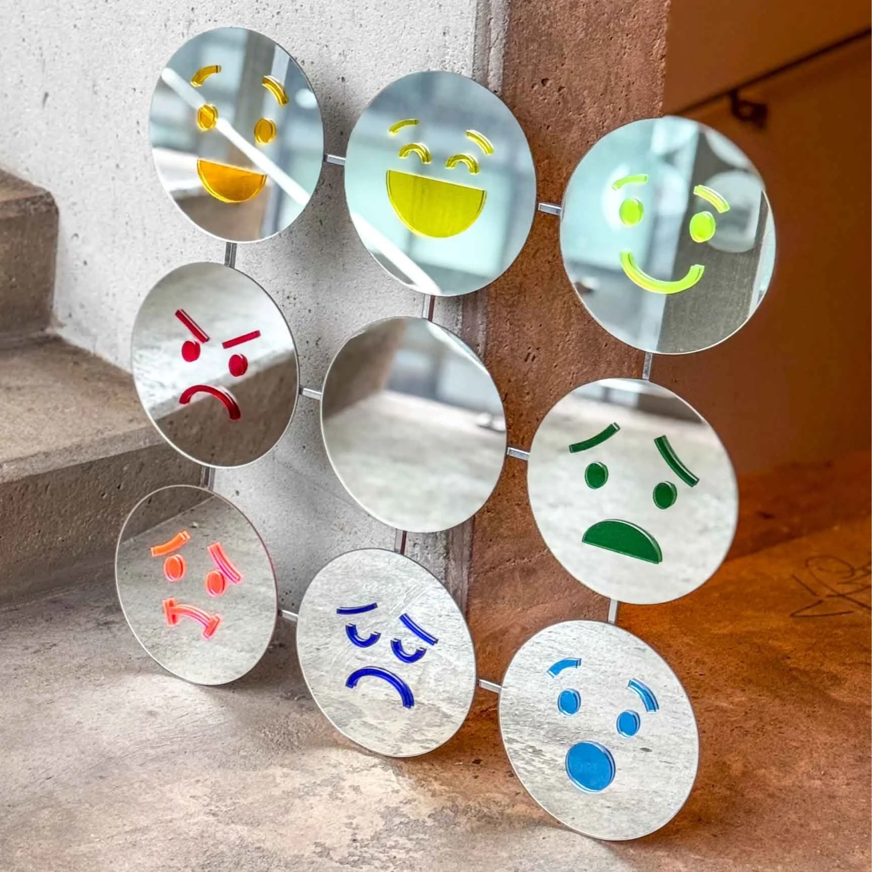    Emotion Mirror    Based on Robert Plutchik’s Wheel of Emotions, this object reflects eight core feelings:  happiness, trust, fear, surprise, sadness, disgust, anger,  and  anticipation . The center mirror is left empty, inviting you to notice, exp