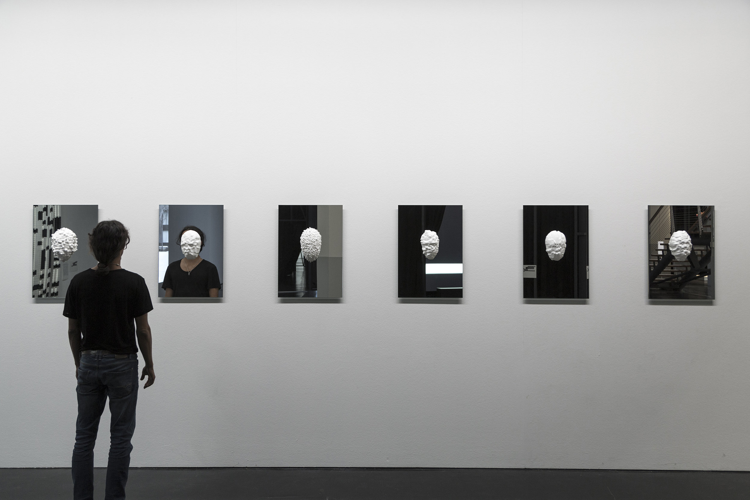   Sterling Crispin,   Data-Masks (Series) ,  2015 3D Printed Nylon, Mirror, Facial Recognition and Detection Algorithms, Genetic algorithms  18 x 26 inches | 45.7 x 66 cm each  || Installation View — ZKM Karlsruhe Museum || 