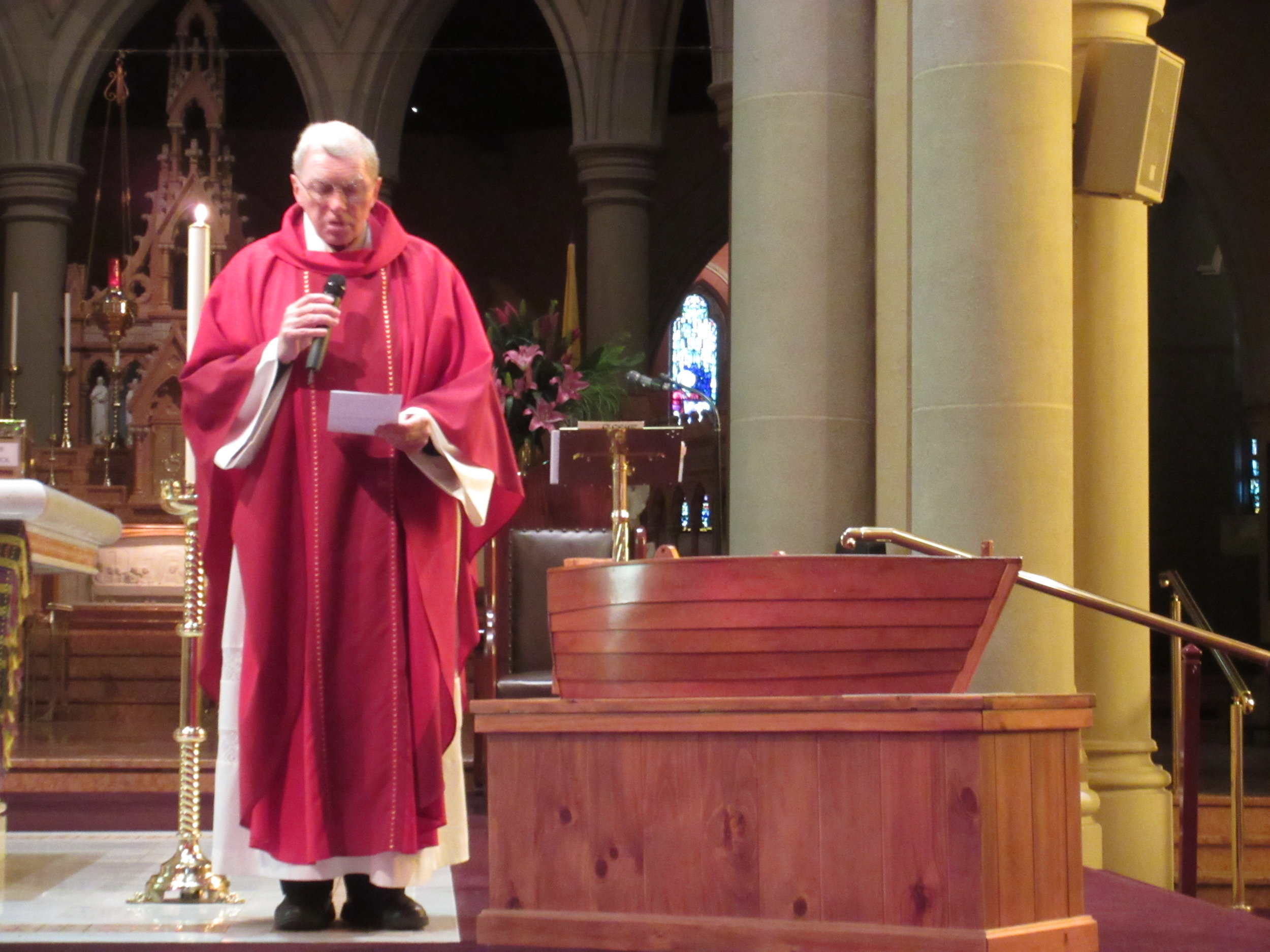 Father Kevin Dillon, the founder of Lifeboat Geelong, blesses the Lifeboat before it is placed in the Narthex of St Mary's Basilica.