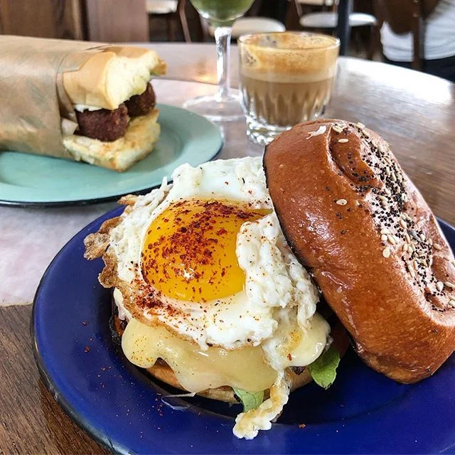 Runny &amp; Everything: sunny side up egg, Miami Smoker&rsquo;s bacon, sharp cheddar, lettuce, heirloom tomato, garlic aioli on a Zak The Baker everything brioche bun // Pan con Croqueta: homemade smoked pork croquetas, gouda, sauce gribiche, homemad