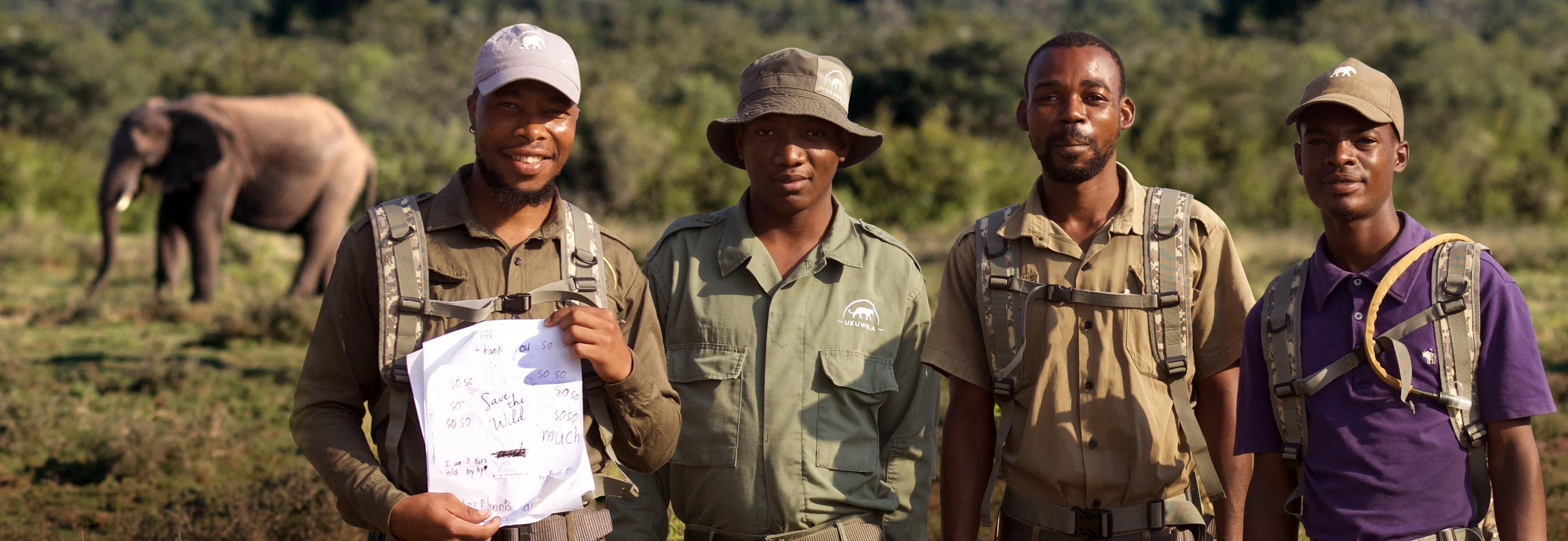 Ukuwela Rangers holding a thank you card from New York girl scouts