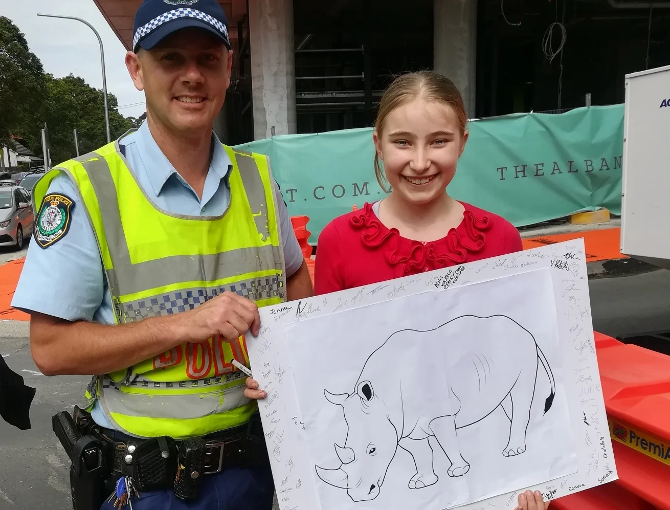 A policeman signed Holly’s rhino poster. He told Holly that if people all around the world helped rhinos, it would really make a difference.