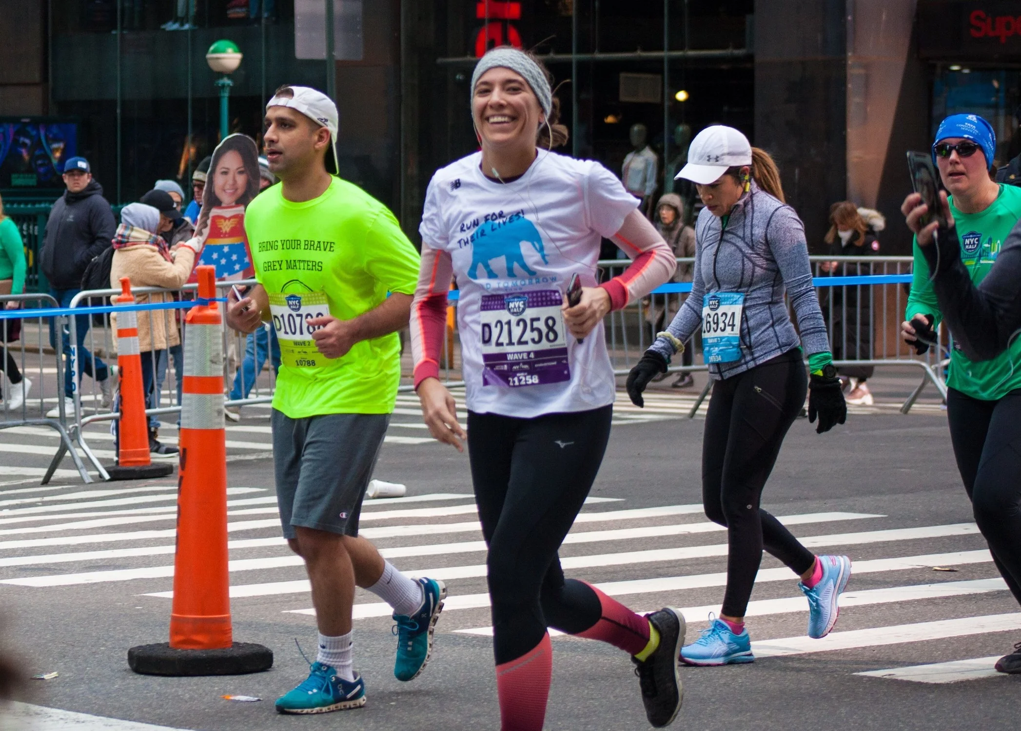Elia Auchane smiles as she passes Mile 11 north of Times Square in Manhattan.