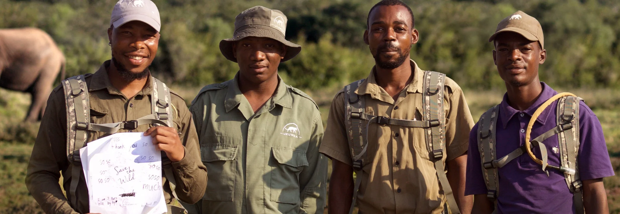 Ukuwela Rangers holding a thank you card from New York girl scouts