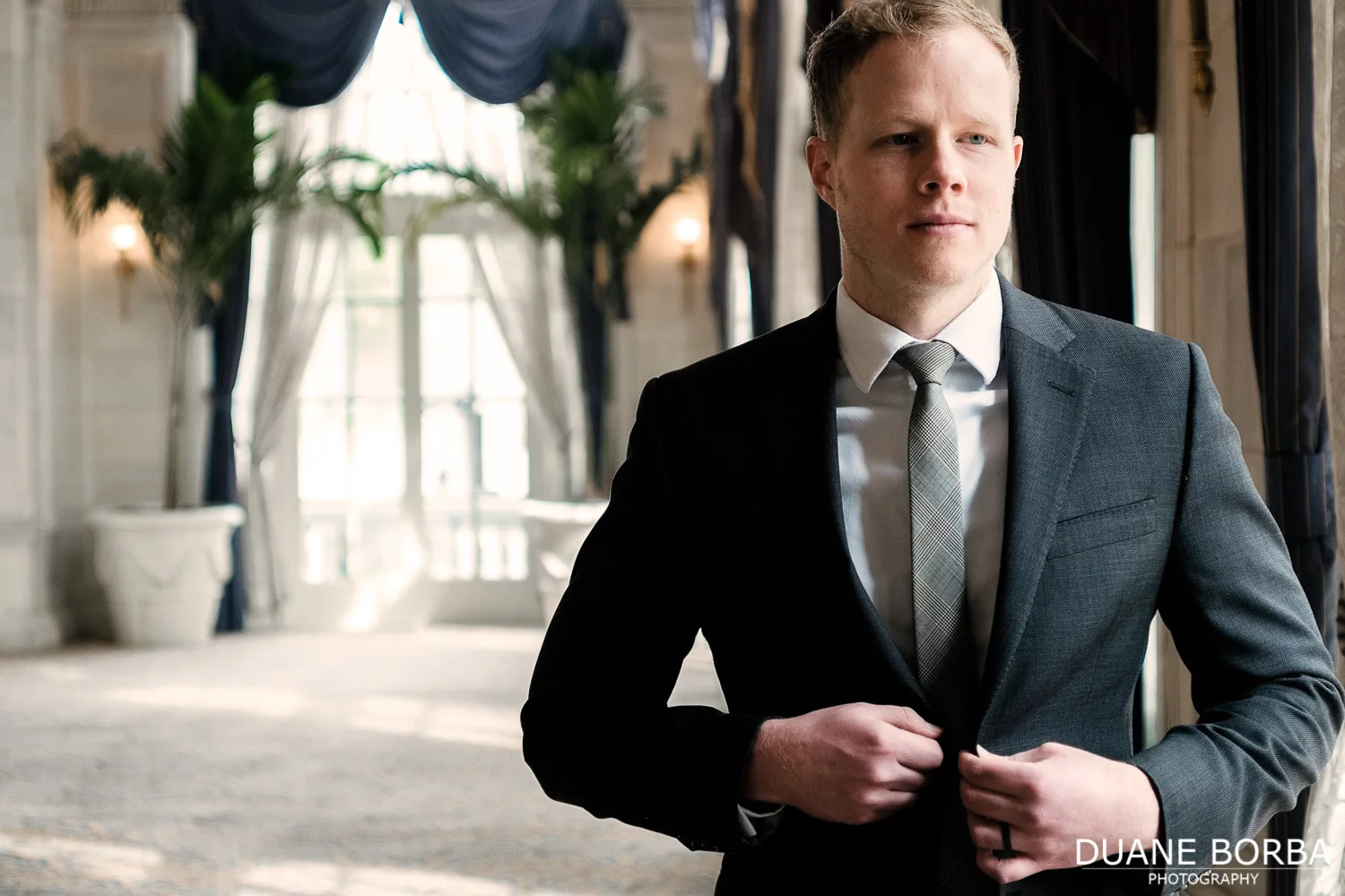 Groom fixing button in Hermitage Hotel