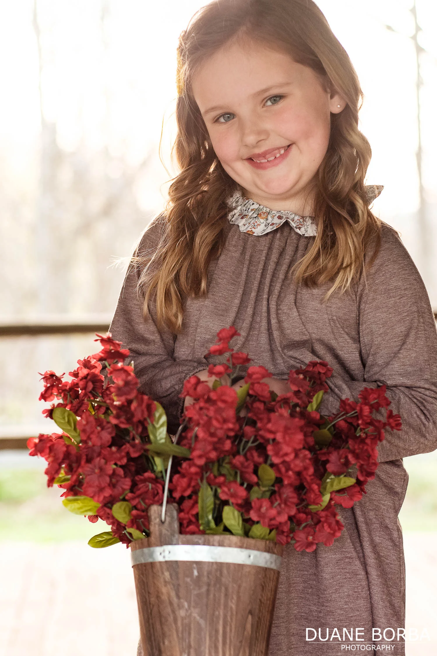 child portrait holding red flowers