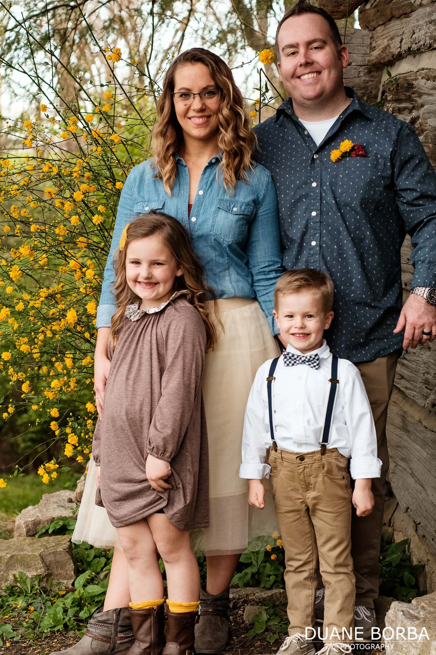Family portrait in front of yellow flowers