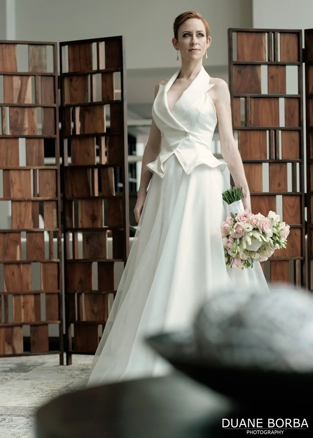 Bride posing with wedding gown and bouquet