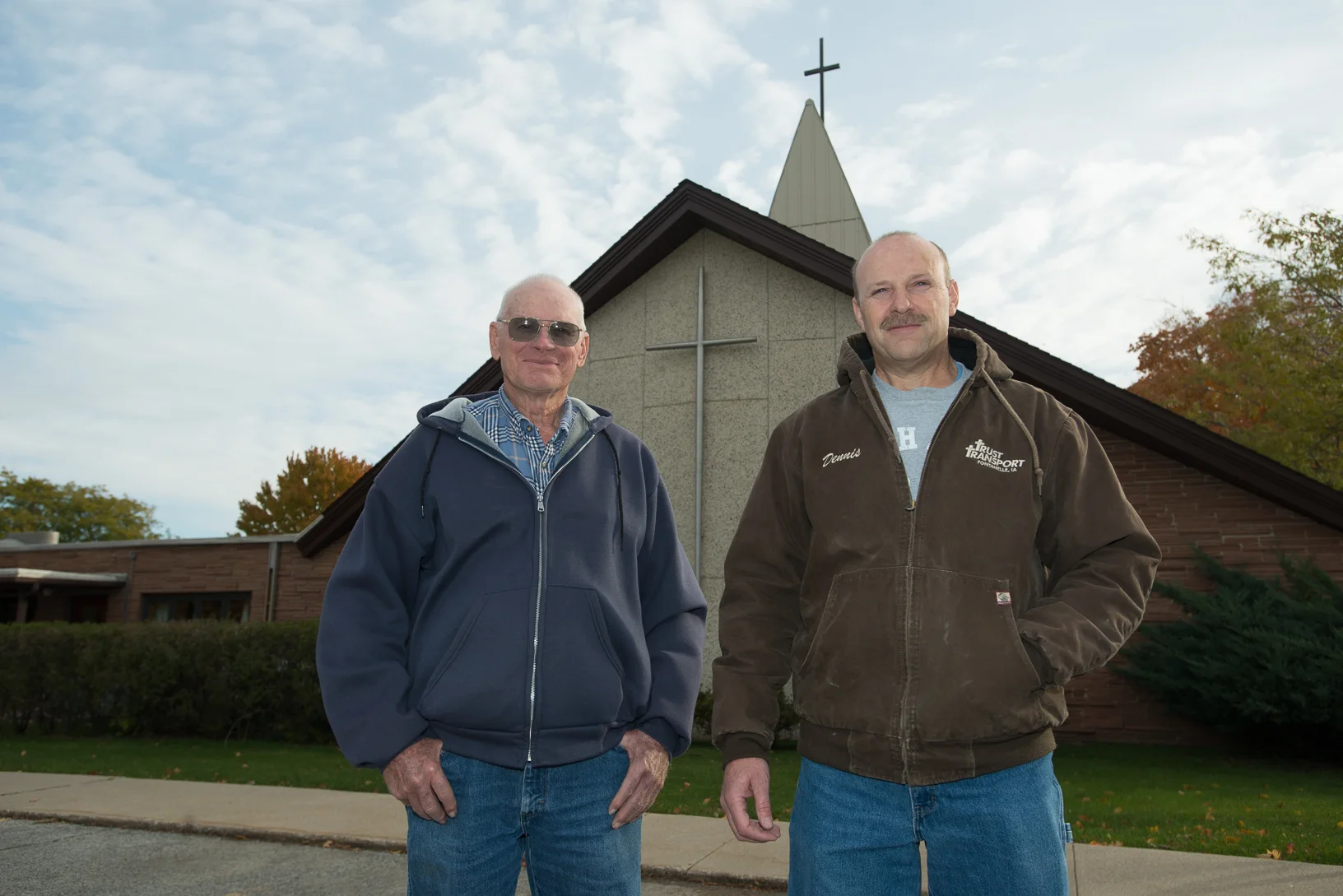 Rolan Jensen (left) and Dennis Lundy stand outside Greenfield United Methodist Church in 2015. They are instrumental in bringing the Fields of Faith project to life each year. Photo credit: Joseph L. Murphy/Iowa Soybean Association.