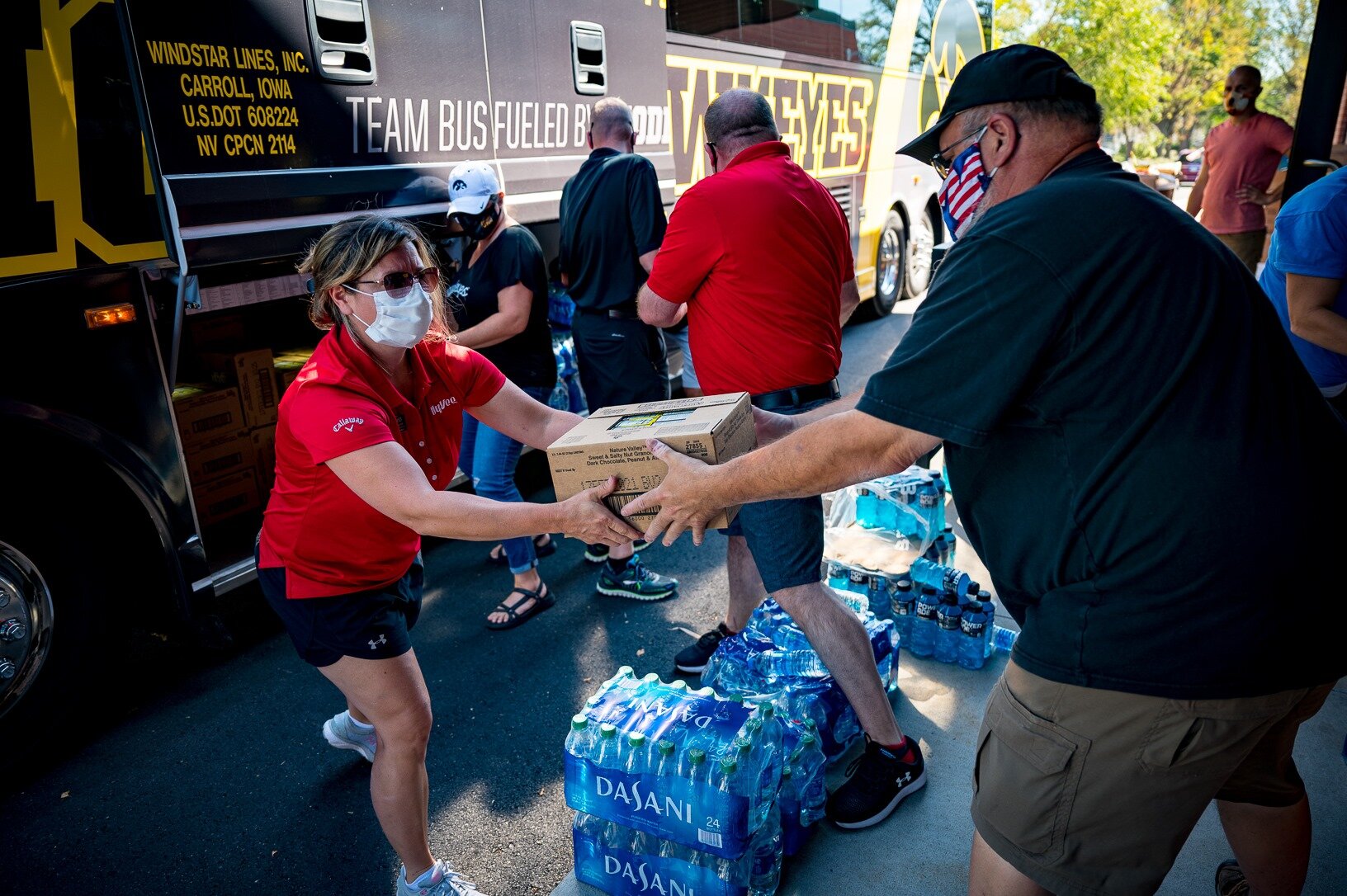  Volunteers from the University of Iowa Athletics give food and water to people impacted by the August 10 derecho storm in Cedar Rapids. 