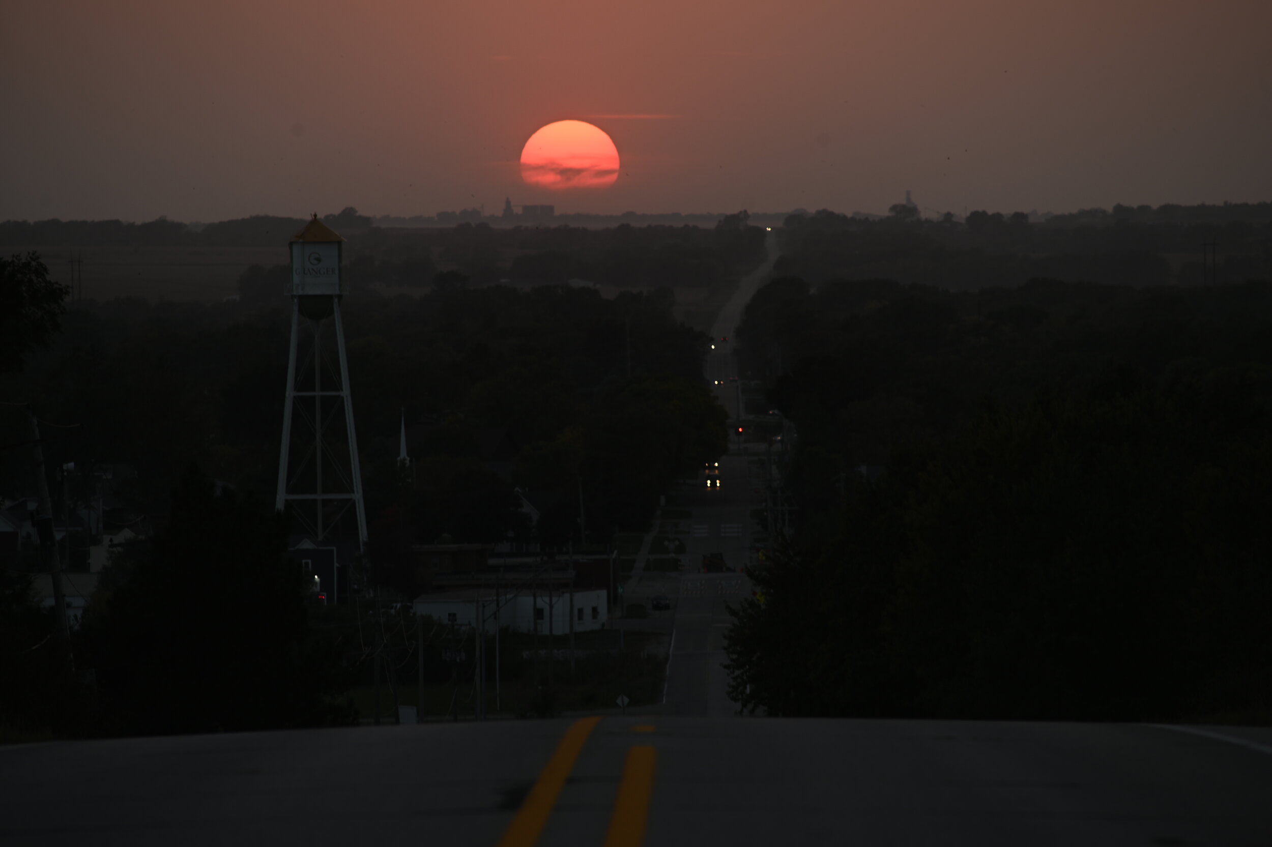  The sun dips below the horizon looking west from Granger. Wildfires in California created hazy sunsets for several weeks in Iowa. 
