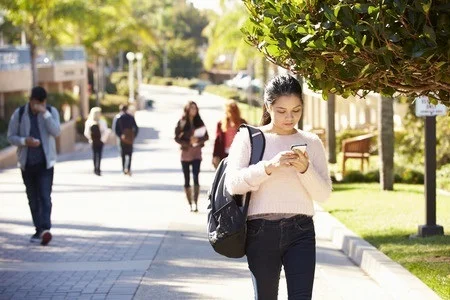 31050666_S_Walking_Texting_Teen_Women_Backapck.jpg