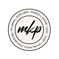 Logo with circular border reading 'Floral Atelier Food Wine Bozeman Montana Est. 2025' surrounding stylized 'mkp' initials in the center.