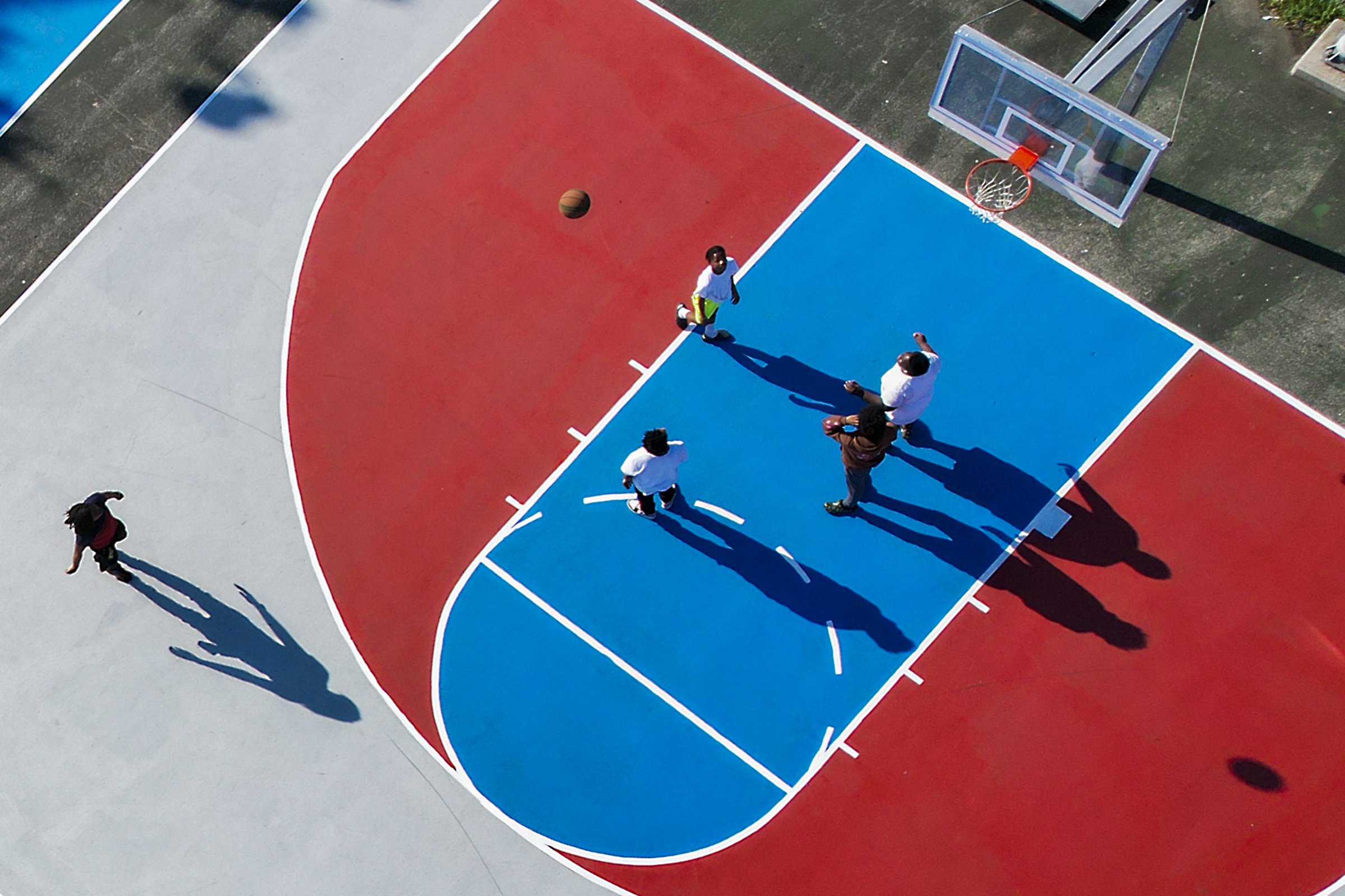  Teens play on the renovated basketball courts at the Hank Gathers Recreation Center in North Philadelphia on July 21, 2022. 