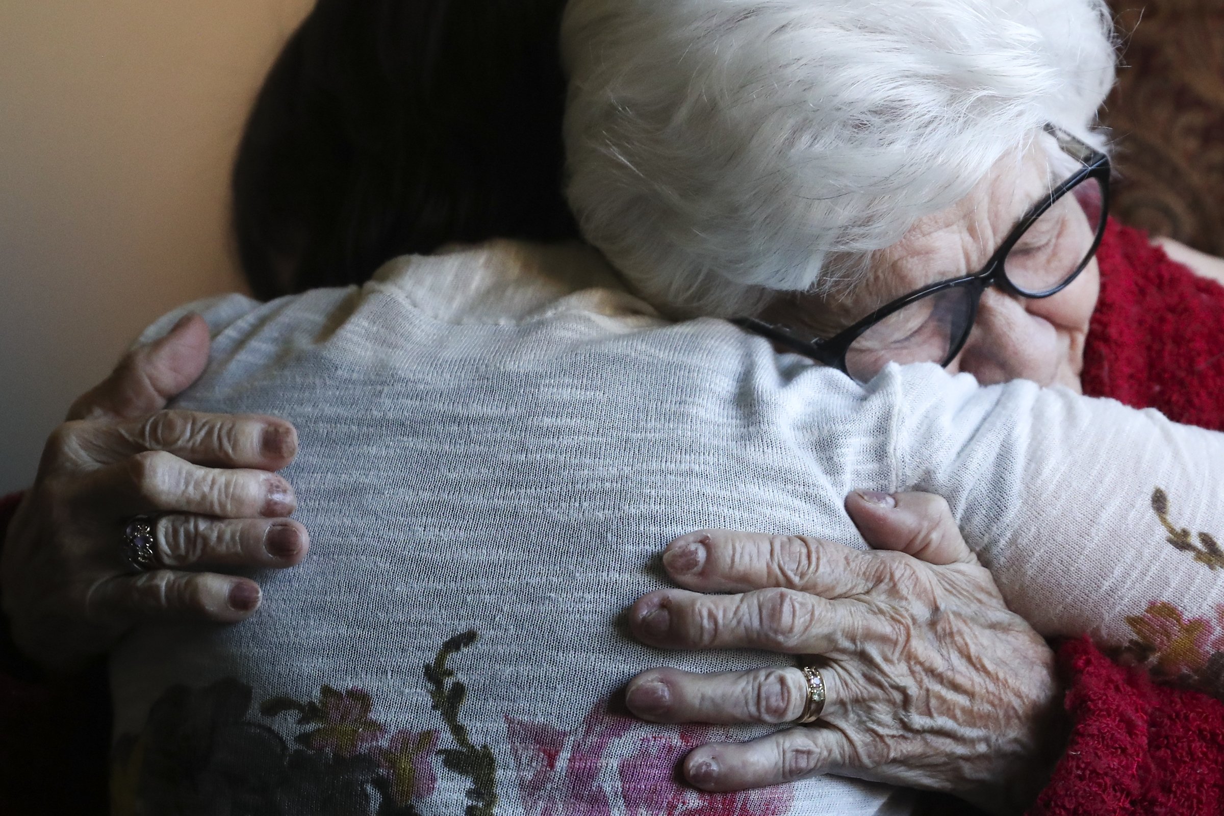  Belle Sandella, an end of life doula, is hugged by Dorcas Miller, 94, who has dementia, inside Miller’s home at the Redeemer Village in Huntingdon Valley, Pa. on Thursday, March 30, 2023. Sandella is one of a few doulas who rotates and takes care of