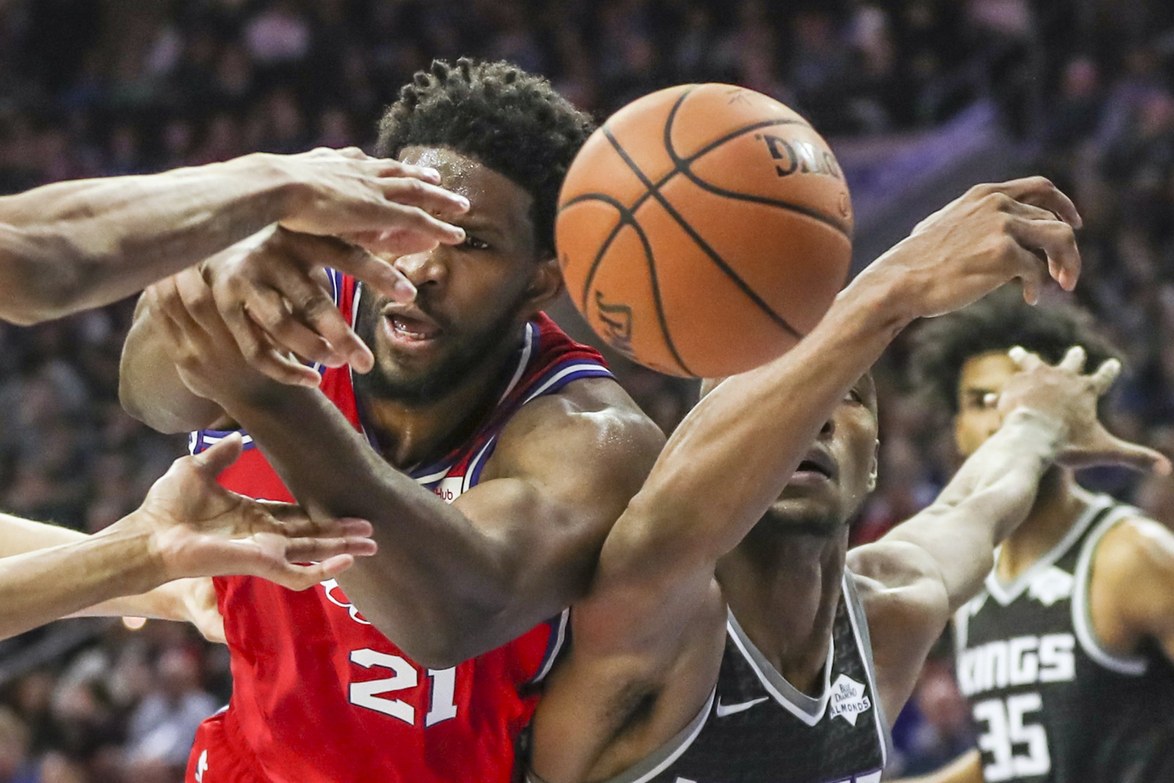  Sixers center Joel Embiid battles for an offensive rebound against Sacramento Kings’ Harry Giles III in the fourth quarter of a game at the Wells Fargo Center in Philadelphia on March 15, 2019. 
