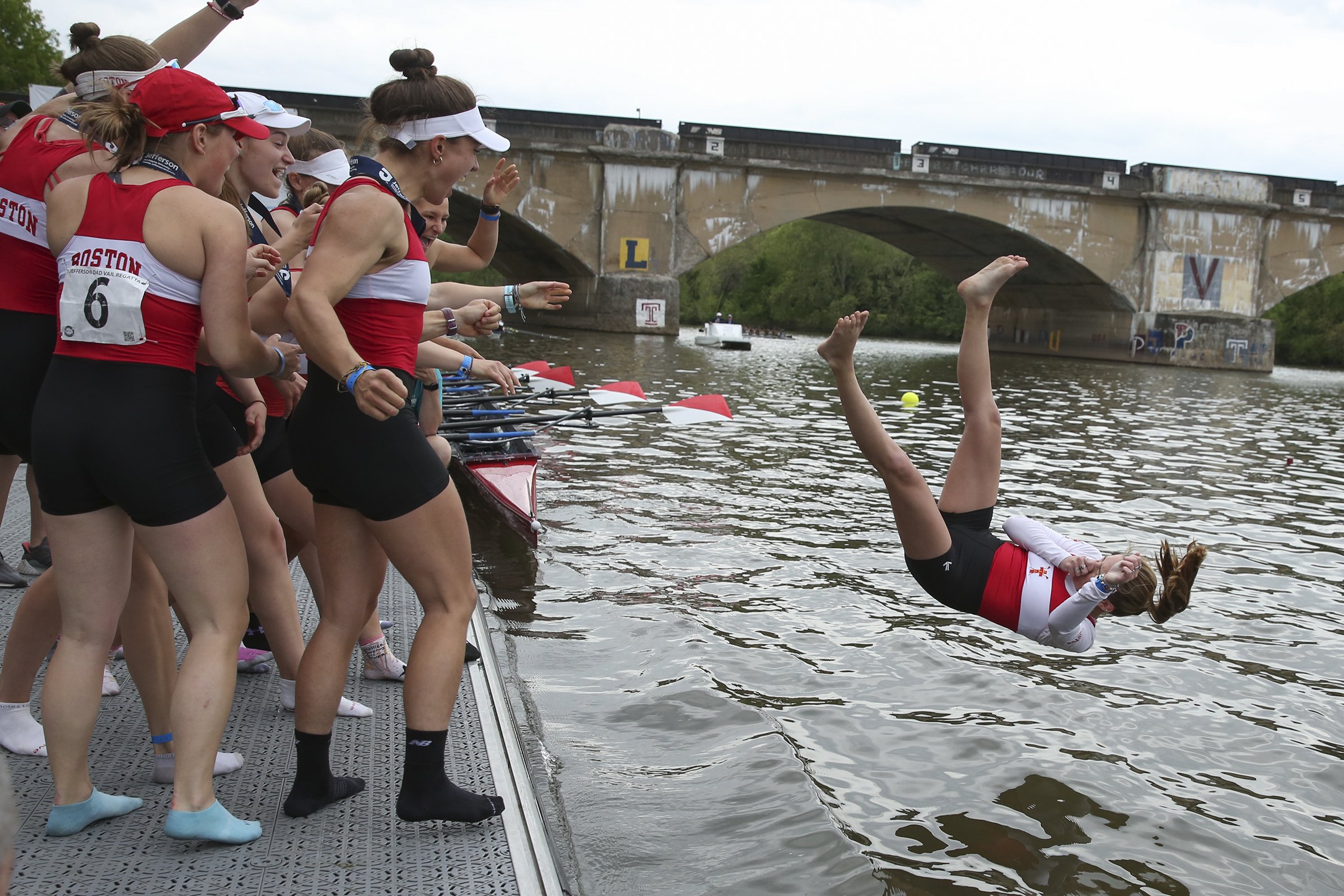  The Boston women's rowing team throws their coxswain in the water after winning first place in the Women's Varsity Heavyweight Eight race at the 81st annual Dad Vail Regatta in Philadelphia on May 11, 2019. 