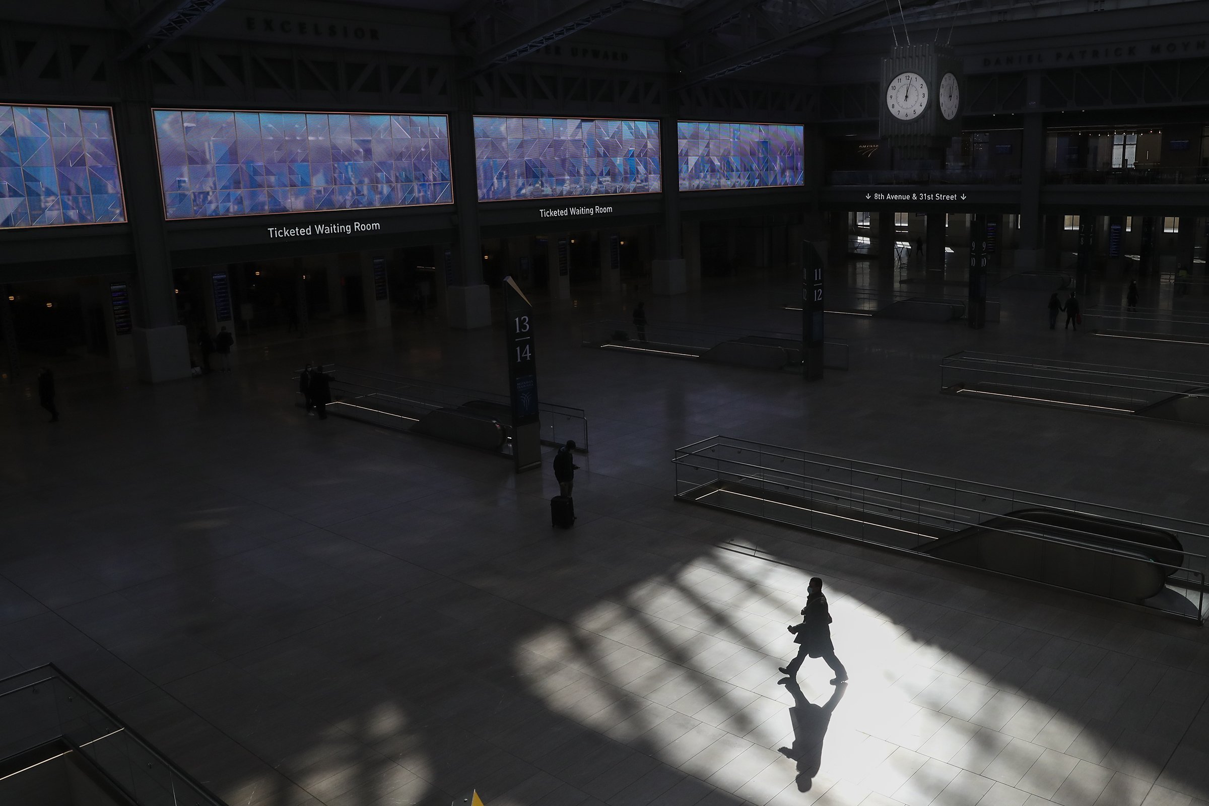  A passenger is silhouetted at the new Moynihan Train Hall in New York on Thursday, Jan. 21, 2021. 