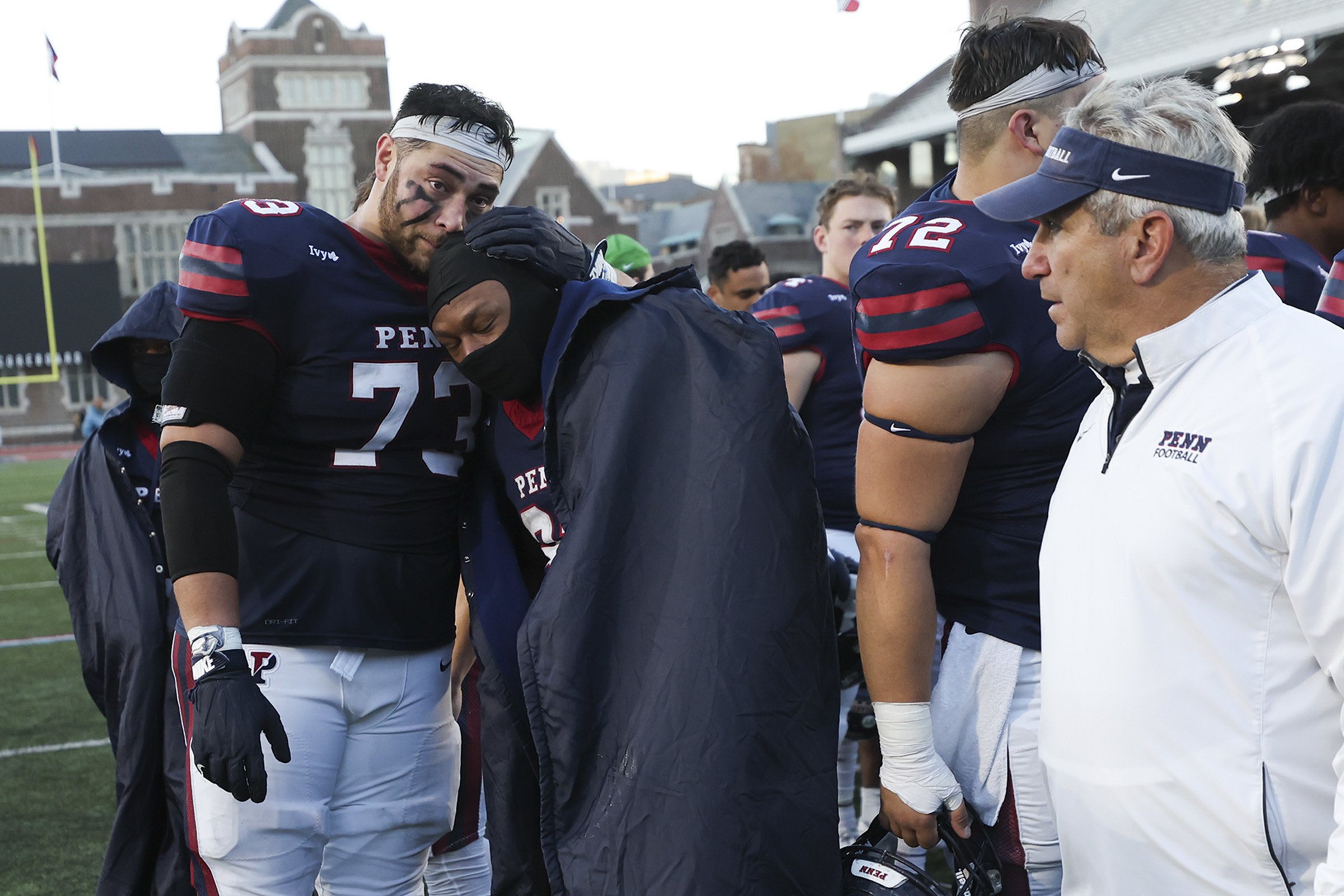  Penn players embrace after their final game of the season in a 31-24 loss to Princeton at Franklin Field in Philadelphia on Nov. 18, 2023. 