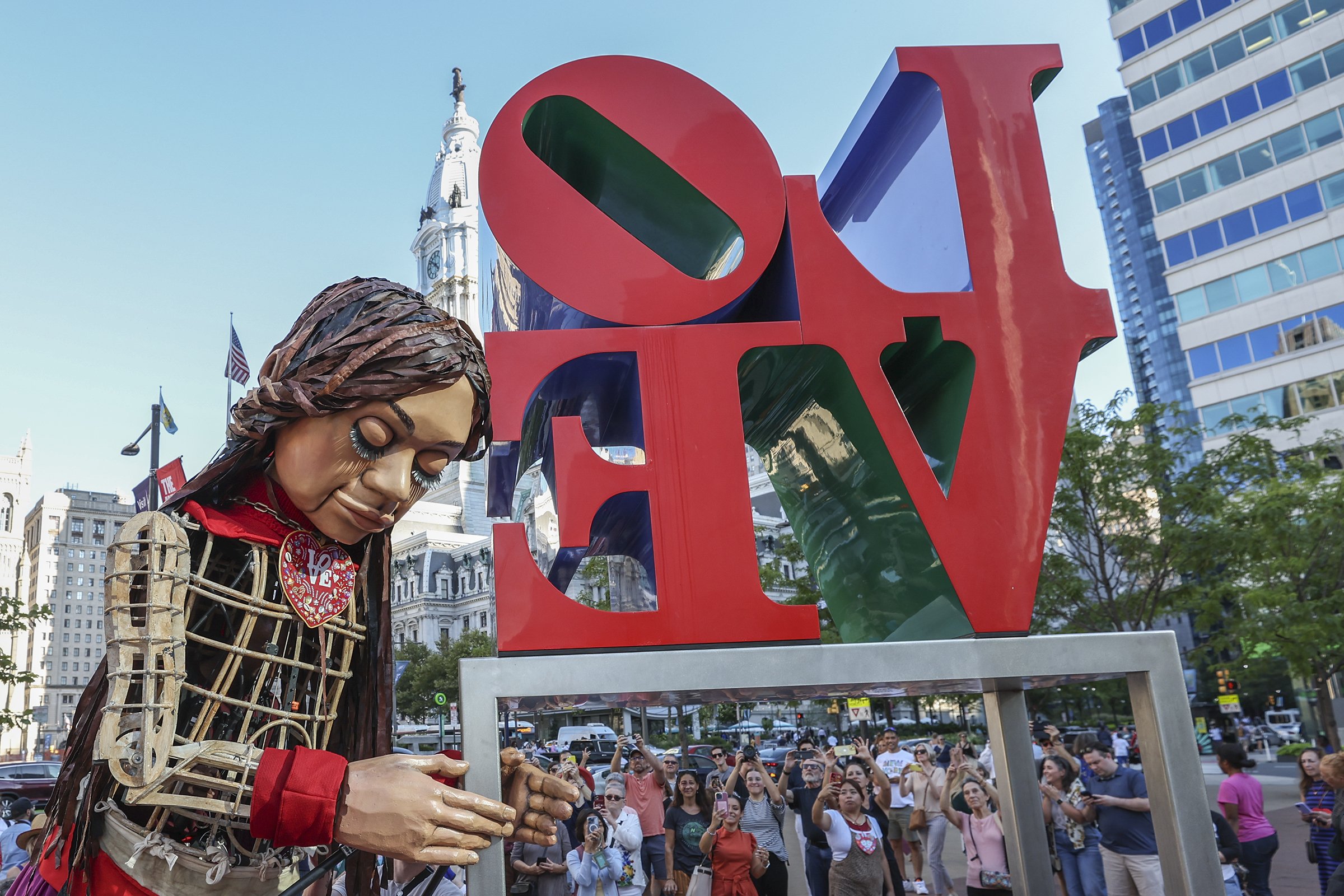  Little Amal rests her head on the Love sign at Love Park in Philadelphia, her last stop in the city, on Sept. 14, 2023. Little Amal, a 12-foot puppet of a 10-year-old Syrian refugee girl and global symbol of human right, spent two days in Philadelph