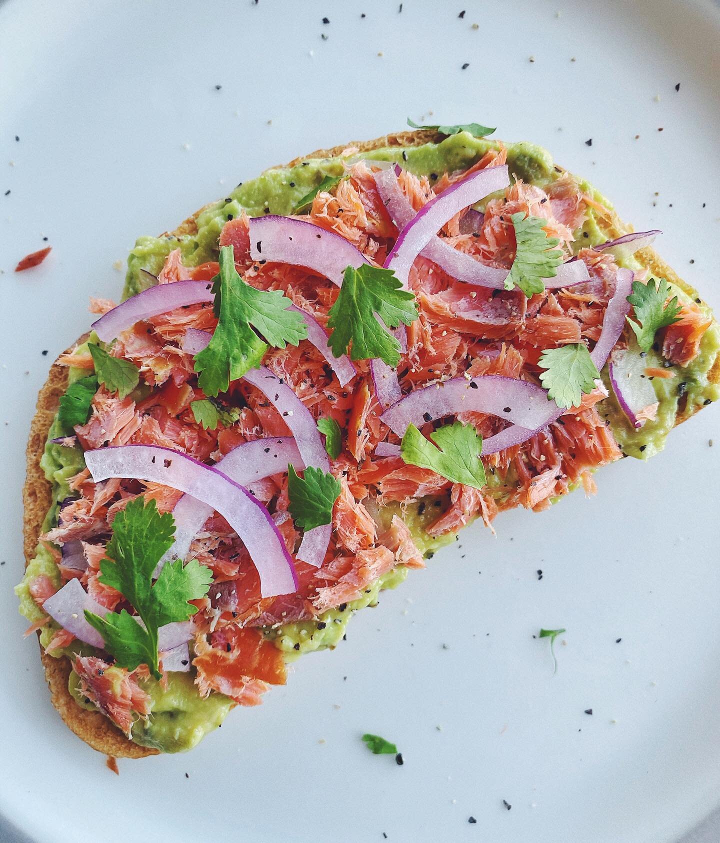 Sourdough toast with mashed avocado, smoked salmon, thinly sliced red onion, fresh cilantro, black pepper and flaky sea salt. 🍞🥑🐟 I eat toast most mornings these days, and I&rsquo;m very lucky that the Whole Foods down the street carries real sour