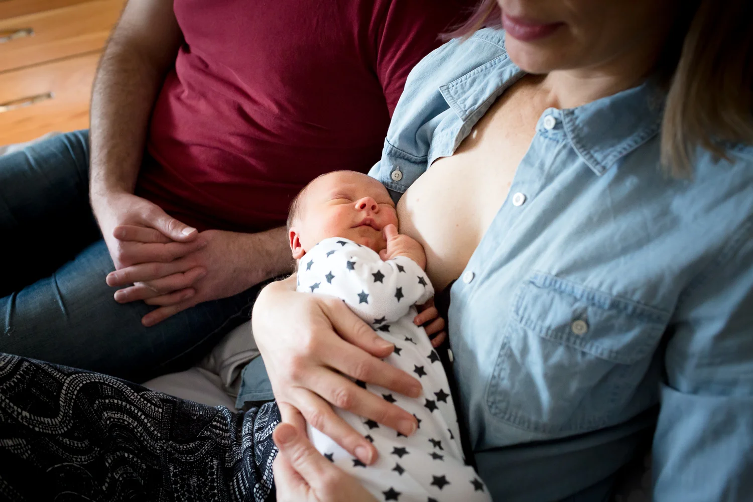Newborn with parents sleeping after a feed